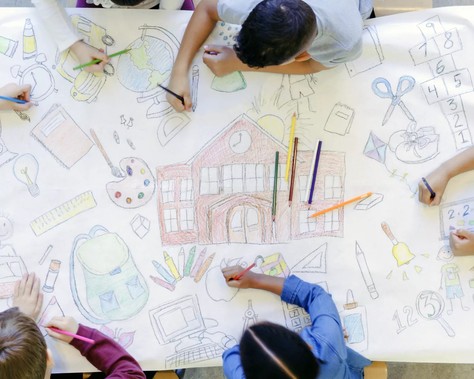 elementary students drawing a mural of school